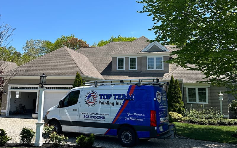 Top Team Painting van in front of a freshly painted Cape Cod home